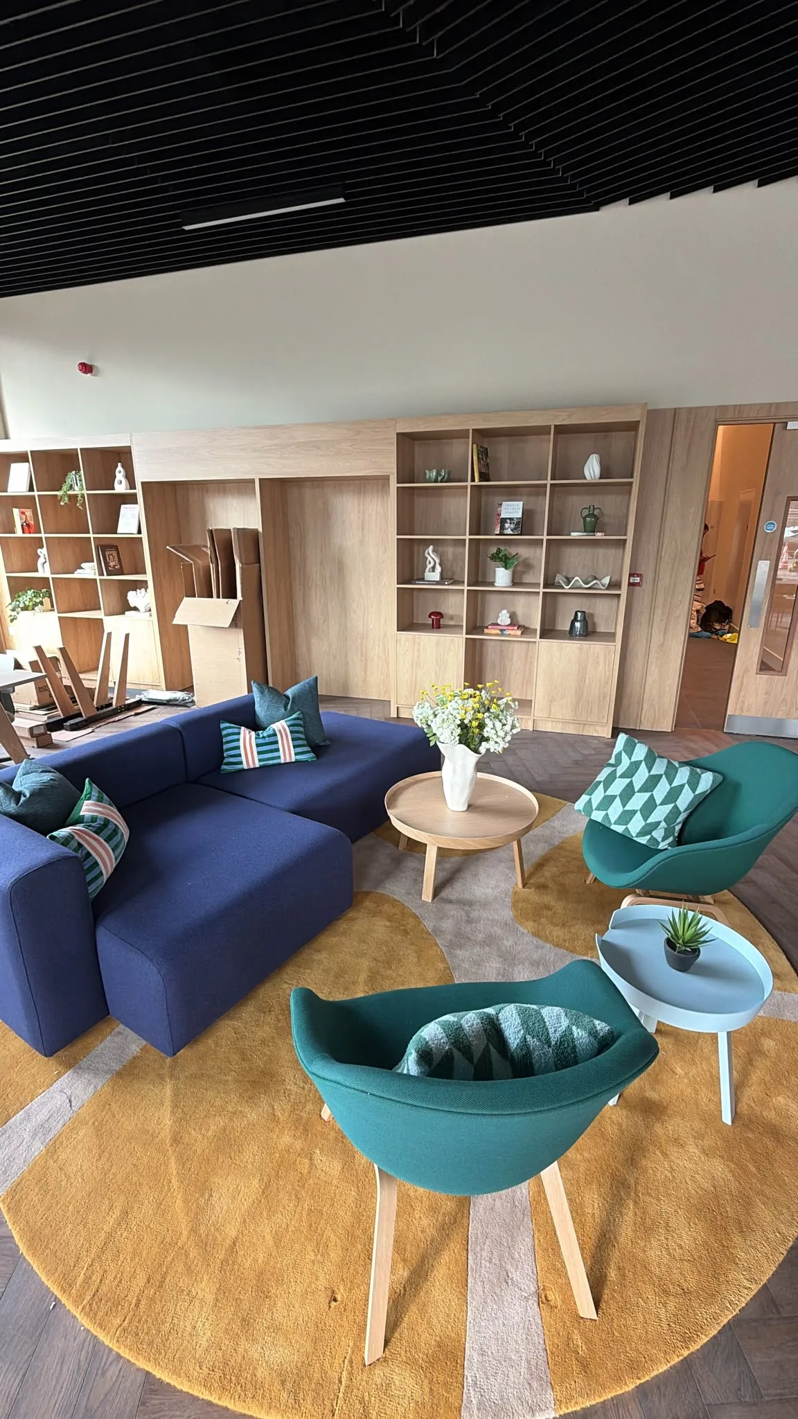 Shared lounge with sofas, armchairs and low tables.