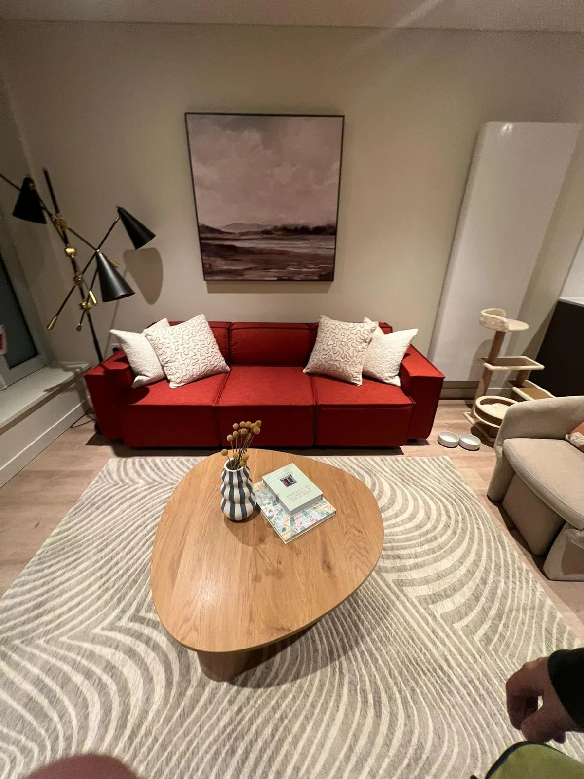 Living room with a red sofa, armchairs and a coffee table.